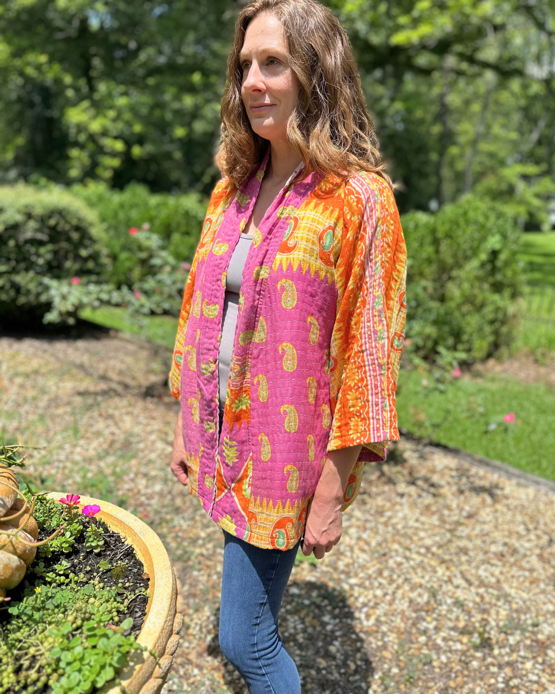 Woman wearing an Upcycled Kantha kimono jacket from TheNickStitch, featuring fuchsia & purple cotton sari fabric.