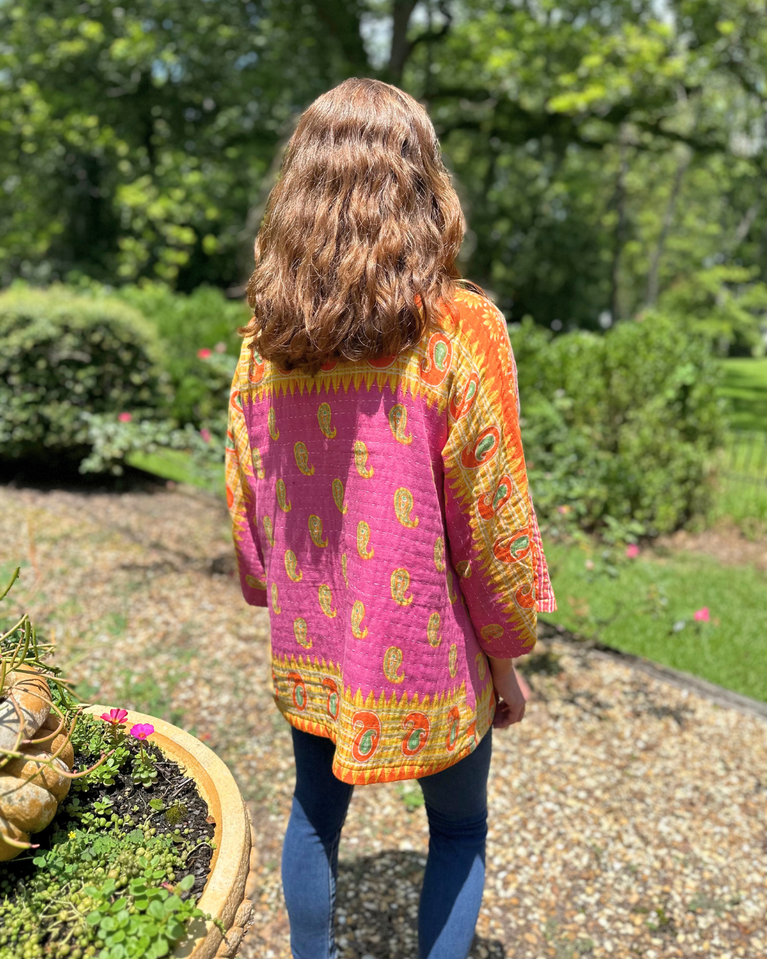 Woman wearing an Upcycled Kantha kimono jacket from TheNickStitch, featuring fuchsia & purple cotton sari fabric.