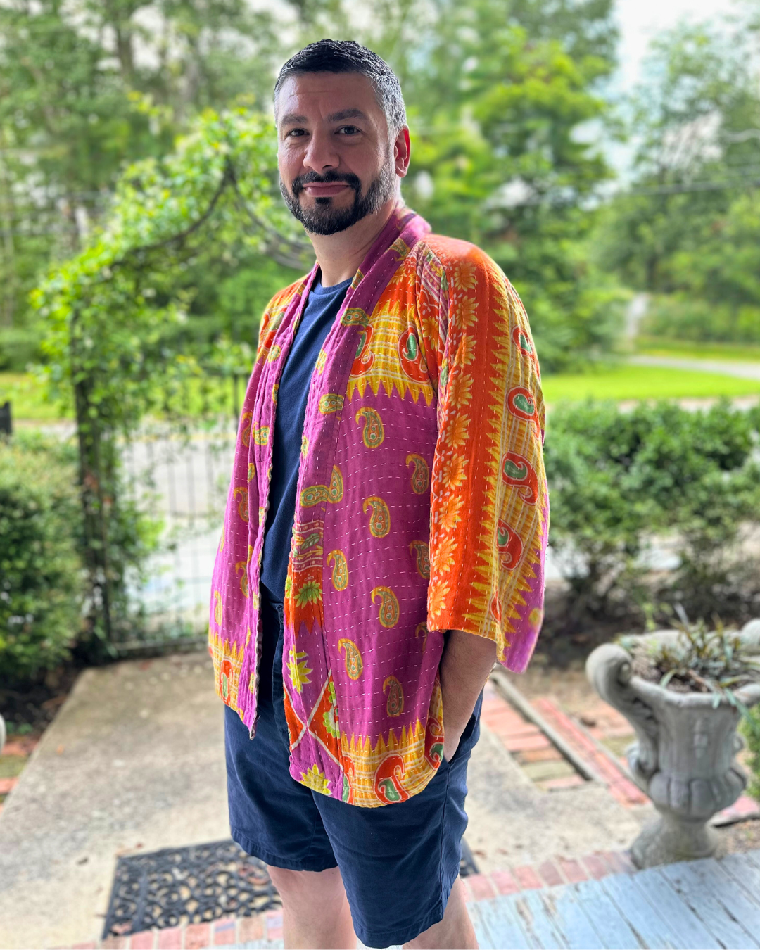 Man wearing an Upcycled Kantha kimono jacket from TheNickStitch, featuring fuchsia & purple cotton sari fabric.